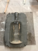 Bottle block in with clay